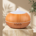 Diffuser on an ivory pedestal with a softly lit botanical background